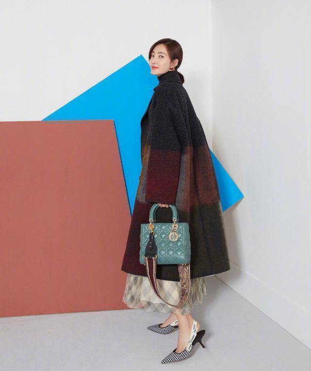 佟丽娅身穿的是一件黑色与卡其色拼接的风衣,展现落落大方质朴风韵