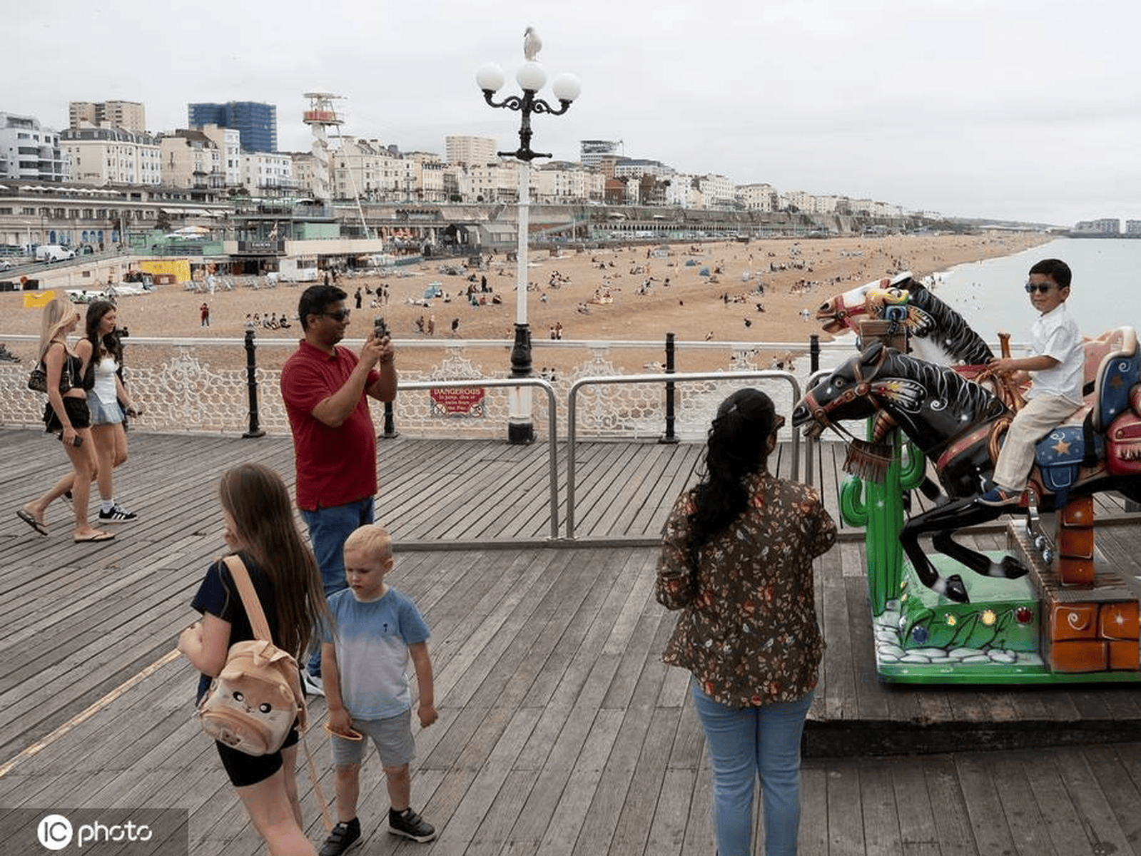 英国布莱顿天气温暖 民众前往海滩玩耍