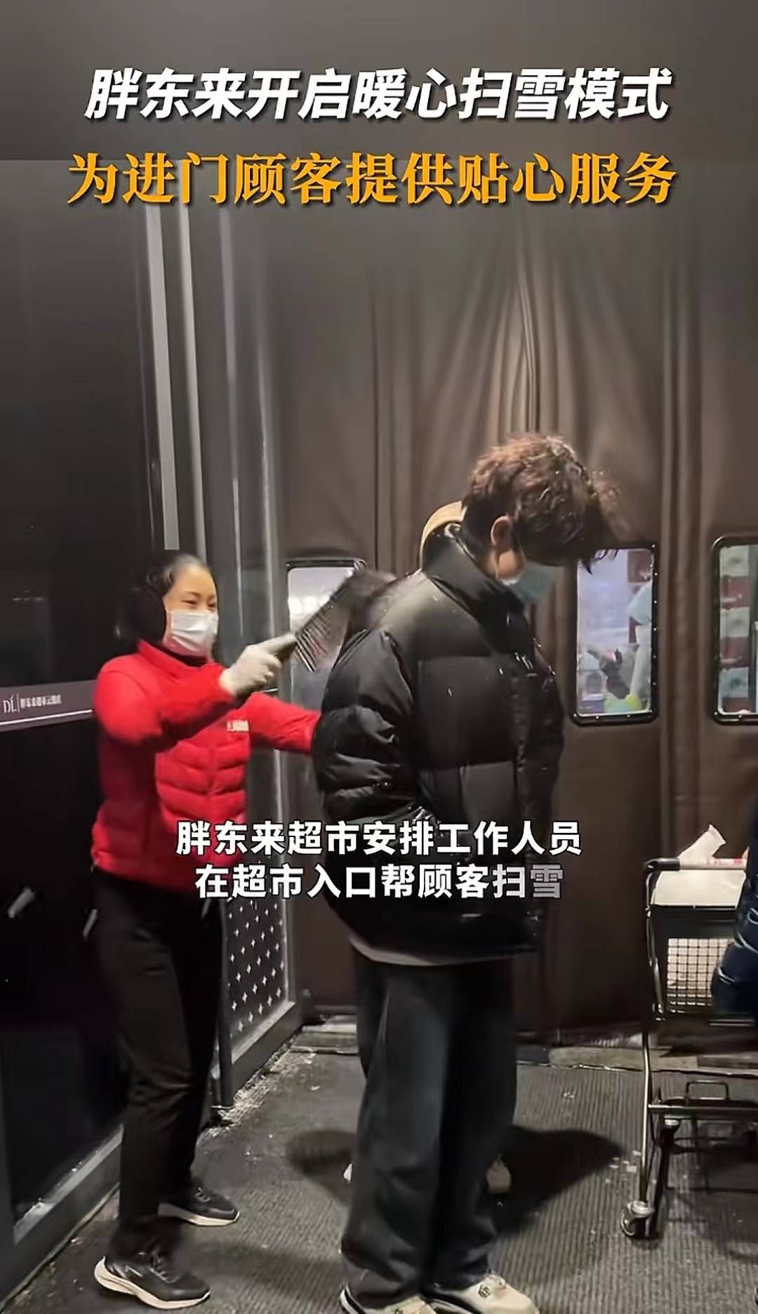 胖东来超市门口工作人员在帮顾客扫雪.